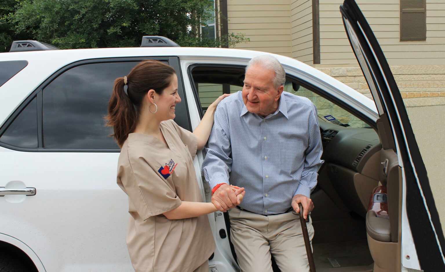 Caring Senior Service franchise helping man out of vehicle
