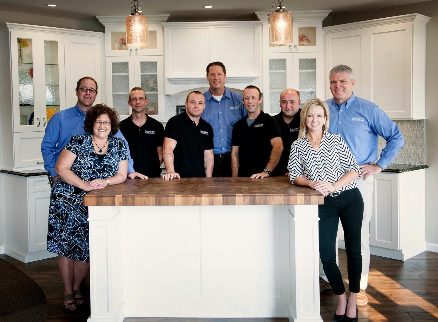 DreamMaker Bath & Kitchen team photo in remodeled kitchen