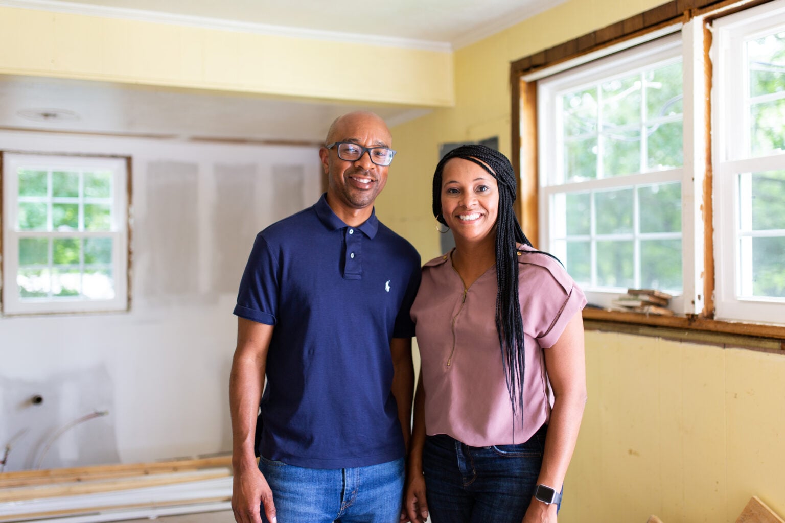 New Again Houses franchise opportunity owners smiling flip houses