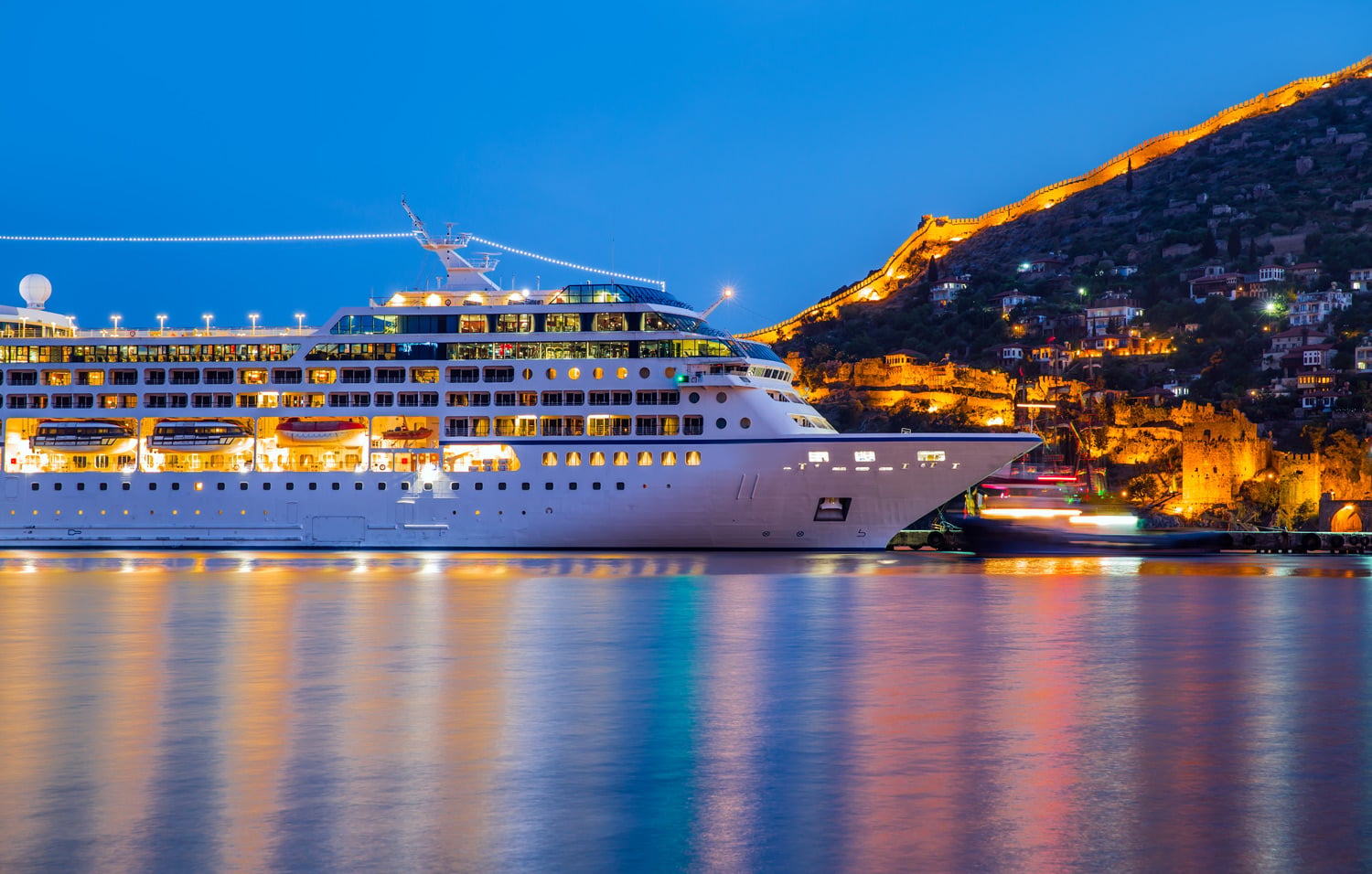 Cruise ship on water city lights
